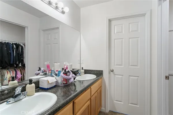 a bathroom with sink mirror and vanity