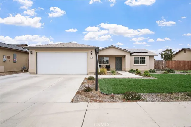 a front view of a house with a garden and plants