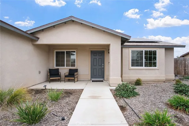 a view of backyard with outdoor seating and plants