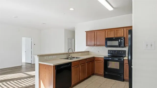 a kitchen with a sink stove and microwave