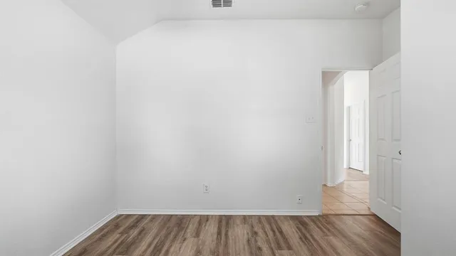 a view of a room with wooden floor