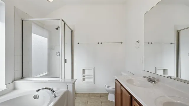 a bathroom with a tub sink and mirror