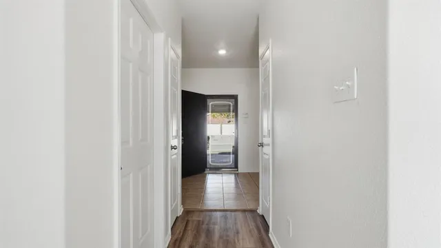 a view of a hallway with wooden floor