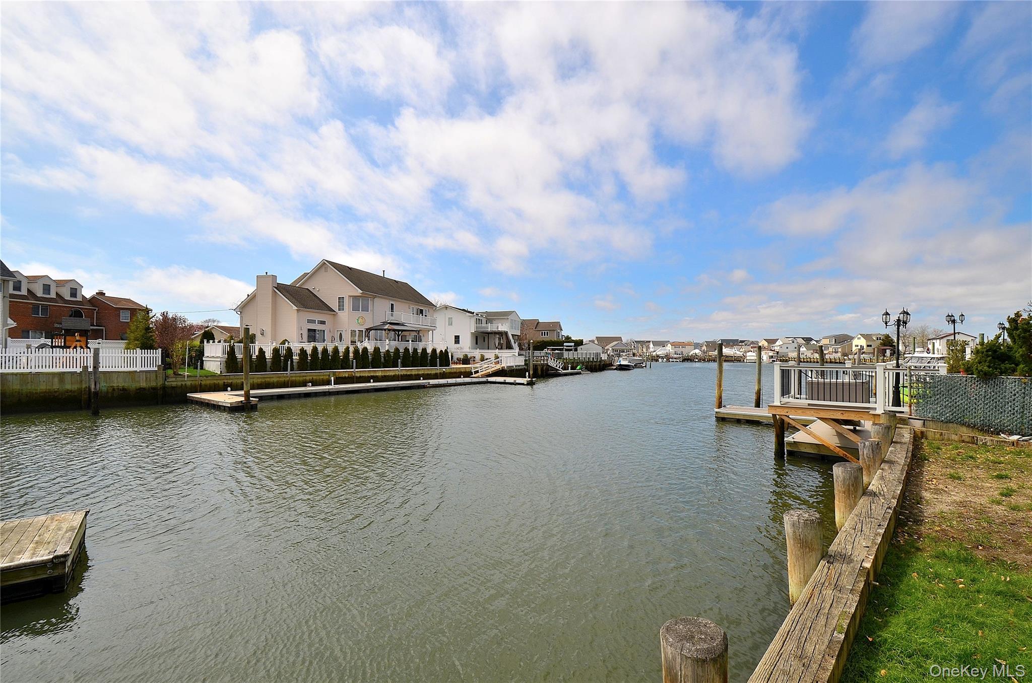 2586 Riverside Drive Wantagh, NY 11793 - Photo 2 of 9 The property features direct water access with a private dock, offering views of the canal and surrounding homes