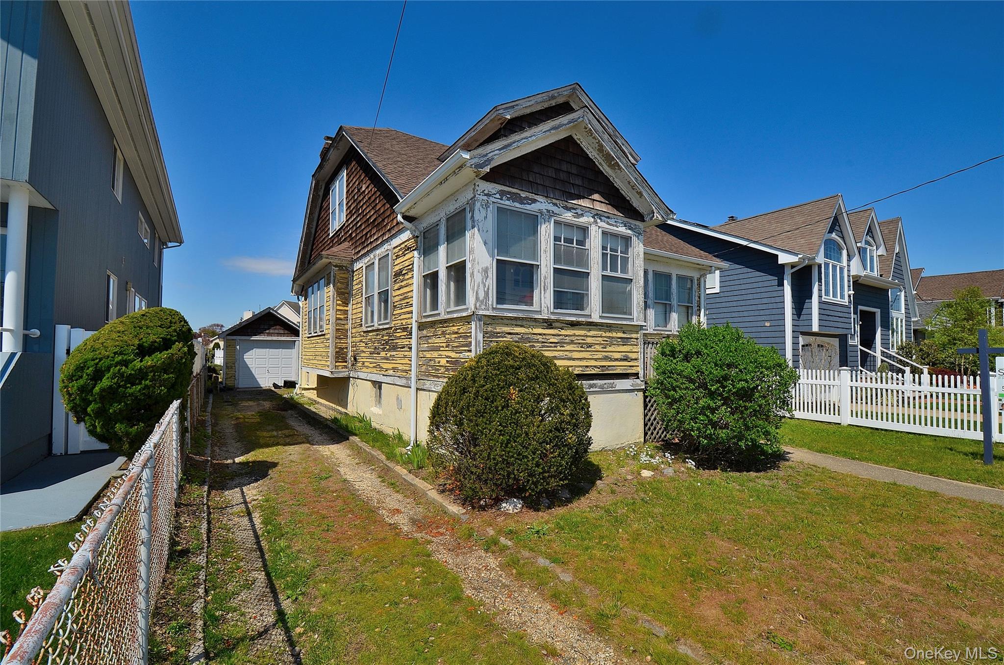 2586 Riverside Drive Wantagh, NY 11793 - Photo 3 of 10 Exterior featuring a gabled roofline, detached garage