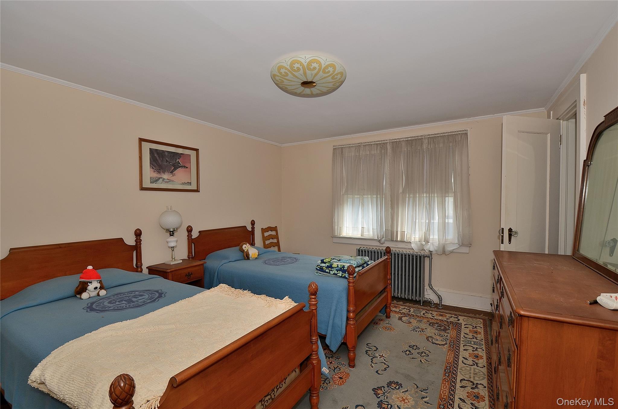 2586 Riverside Drive Wantagh, NY 11793 - Photo 4 of 9 This room features light-colored walls and crown molding