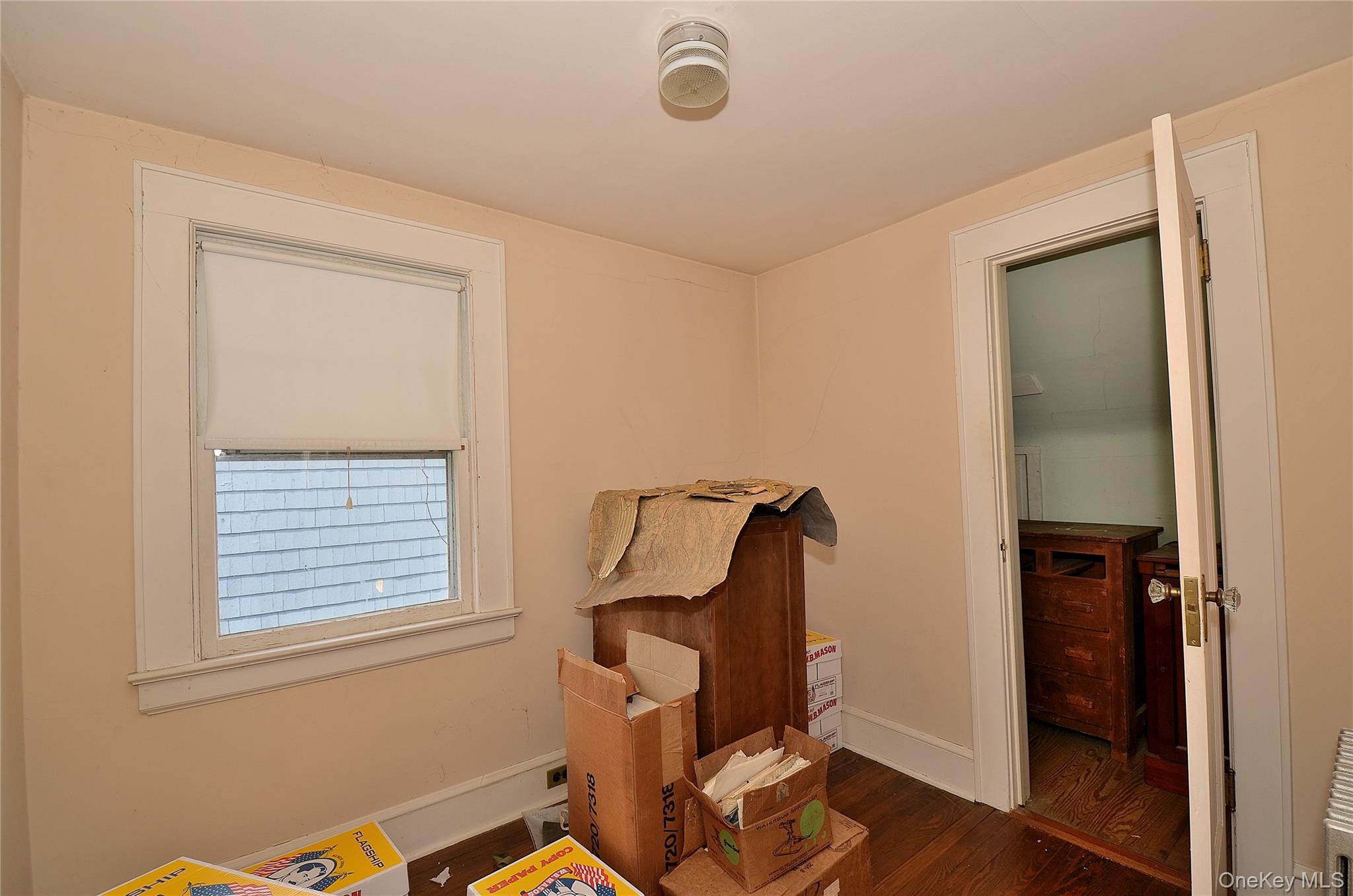 2586 Riverside Drive Wantagh, NY 11793 - Photo 7 of 9 This room features a window with a roller blind and hardwood floors