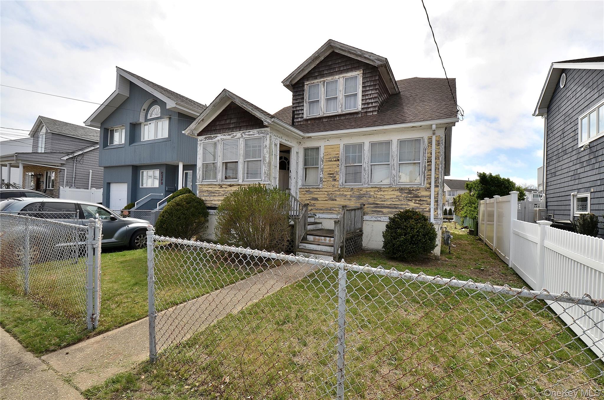 2586 Riverside Drive Wantagh, NY 11793 - Photo 9 of 9 The property features a two-story structure with dormer windows and a front porch