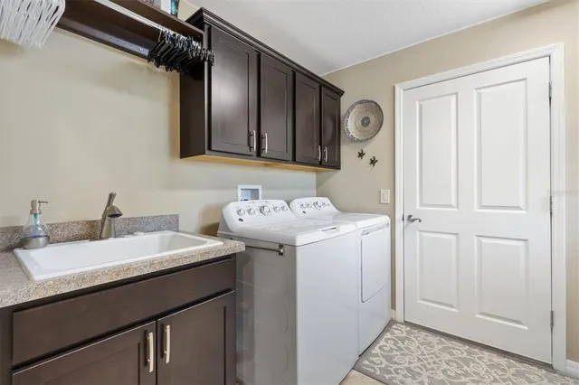 a view of kitchen with refrigerator and window