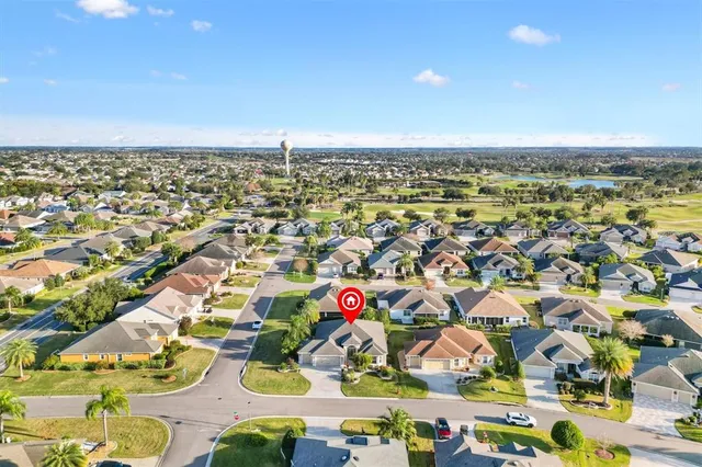 an aerial view of residential houses with outdoor space and swimming pool