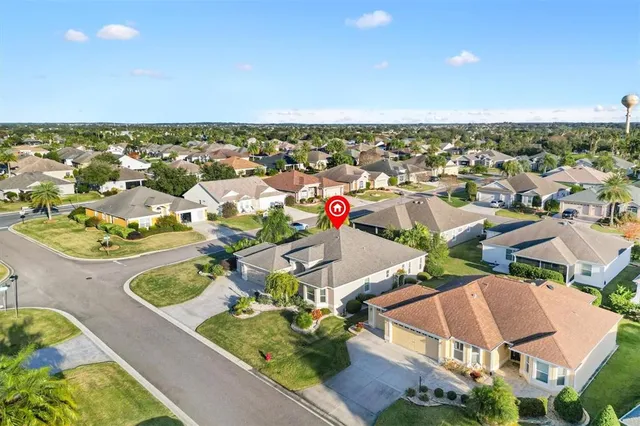 an aerial view of a house with a yard and a fireplace