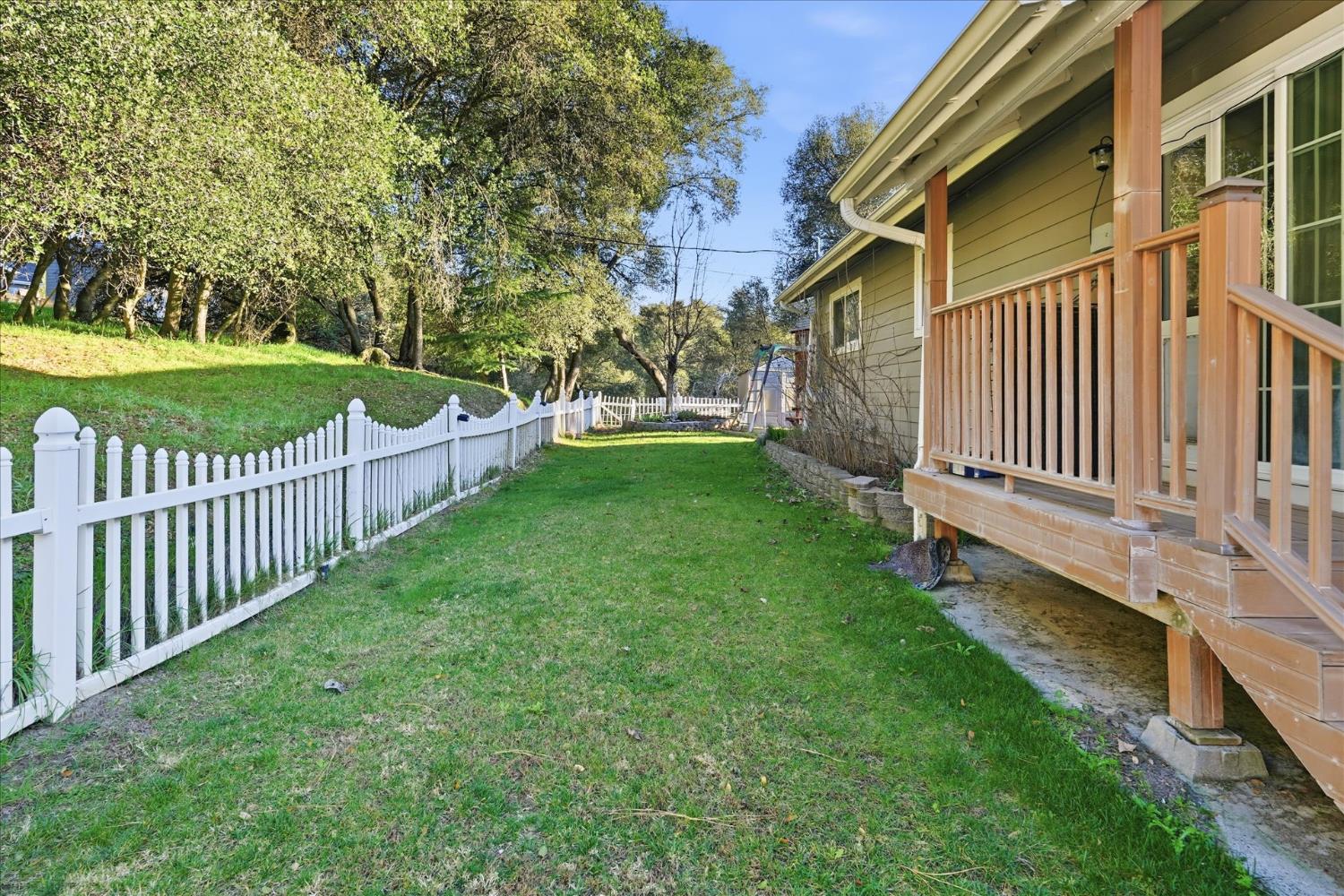 40182 Alerna Way Oakhurst, CA 93644 - Photo 16 of 49 a view of a house with backyard and porch