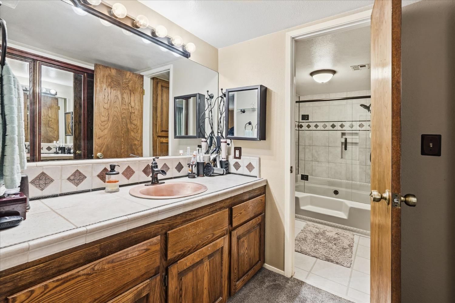 40182 Alerna Way Oakhurst, CA 93644 - Photo 18 of 49 a bathroom with a sink double vanity and a mirror