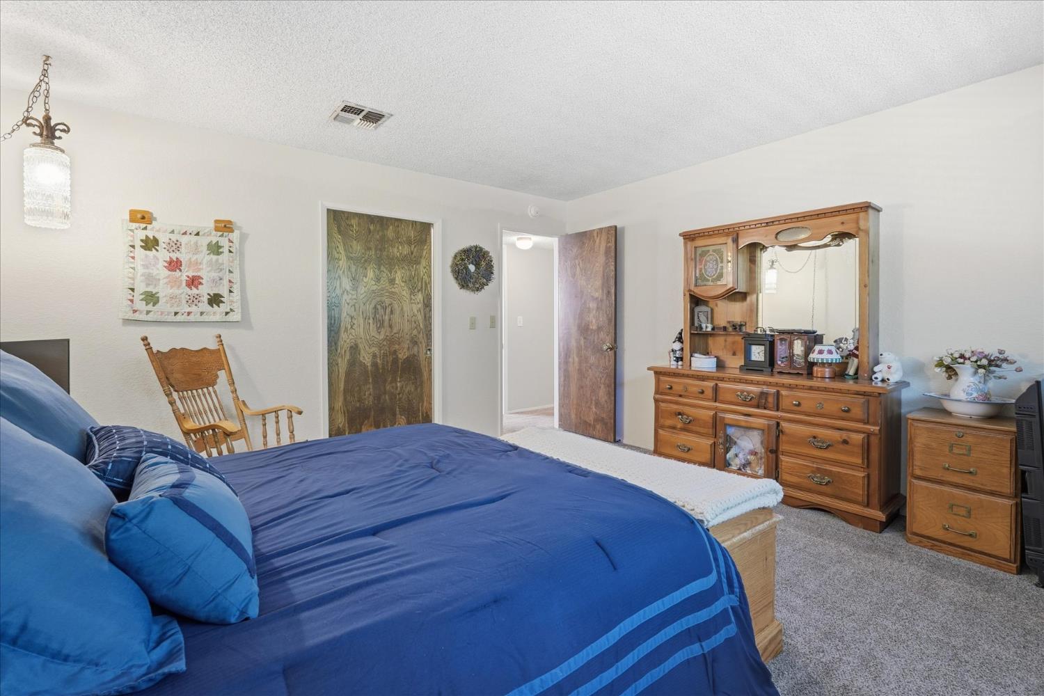 40182 Alerna Way Oakhurst, CA 93644 - Photo 24 of 49 a bedroom with a bed and dresser