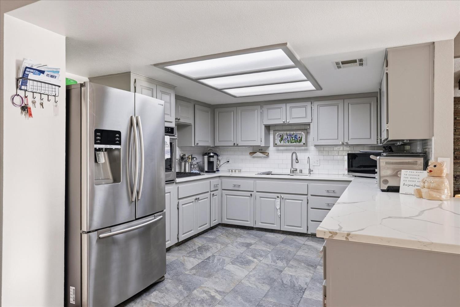 40182 Alerna Way Oakhurst, CA 93644 - Photo 24 of 49 a kitchen with granite countertop stainless steel appliances and refrigerator