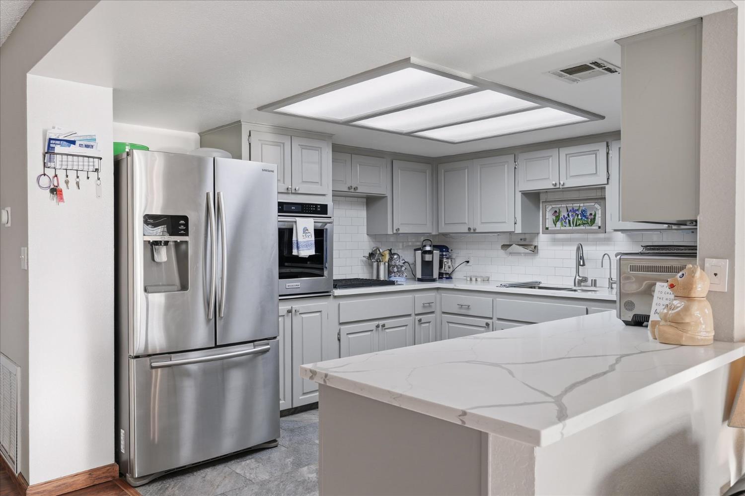 40182 Alerna Way Oakhurst, CA 93644 - Photo 25 of 49 a kitchen with stainless steel appliances a refrigerator sink and cabinets