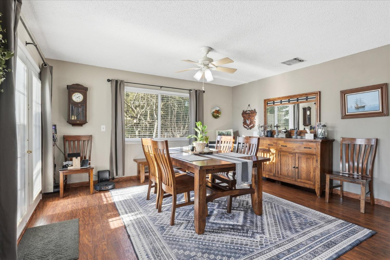 40182 Alerna Way Oakhurst, CA 93644 - Photo 10 of 49 a view of a dining room with furniture window and wooden floor