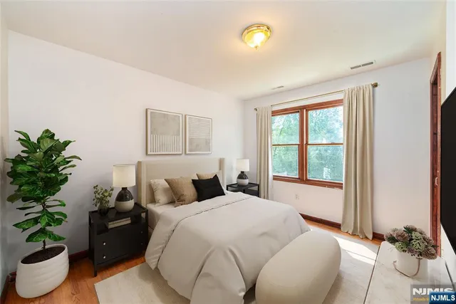 a bedroom with a bed and a potted plant