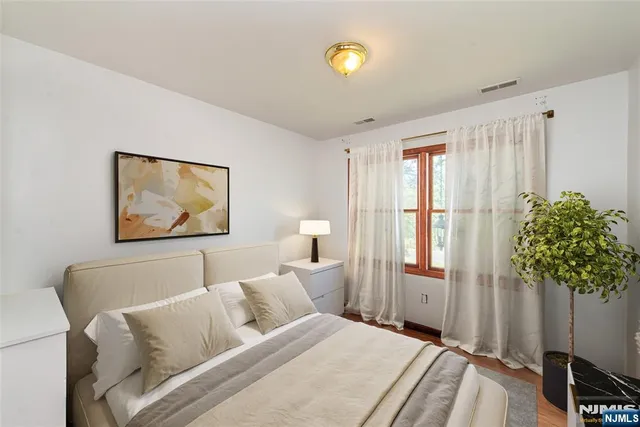 a bedroom with furniture and a potted plant