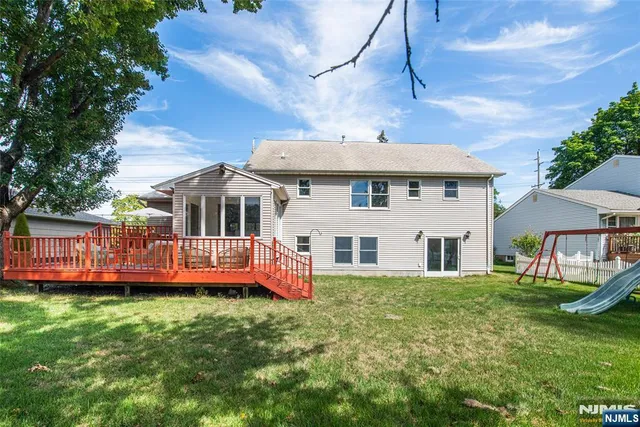 a front view of a house with a garden and deck