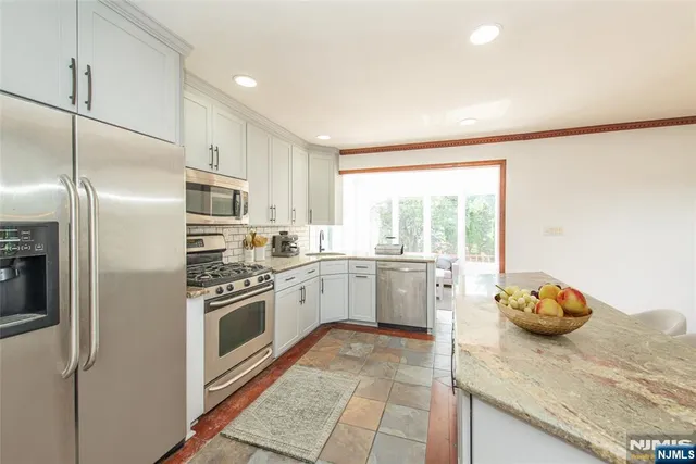 a kitchen with a sink cabinets and stainless steel appliances