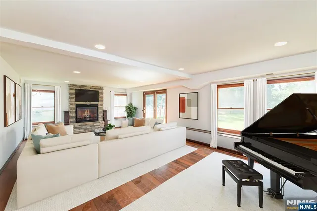 a living room with furniture fireplace and a window