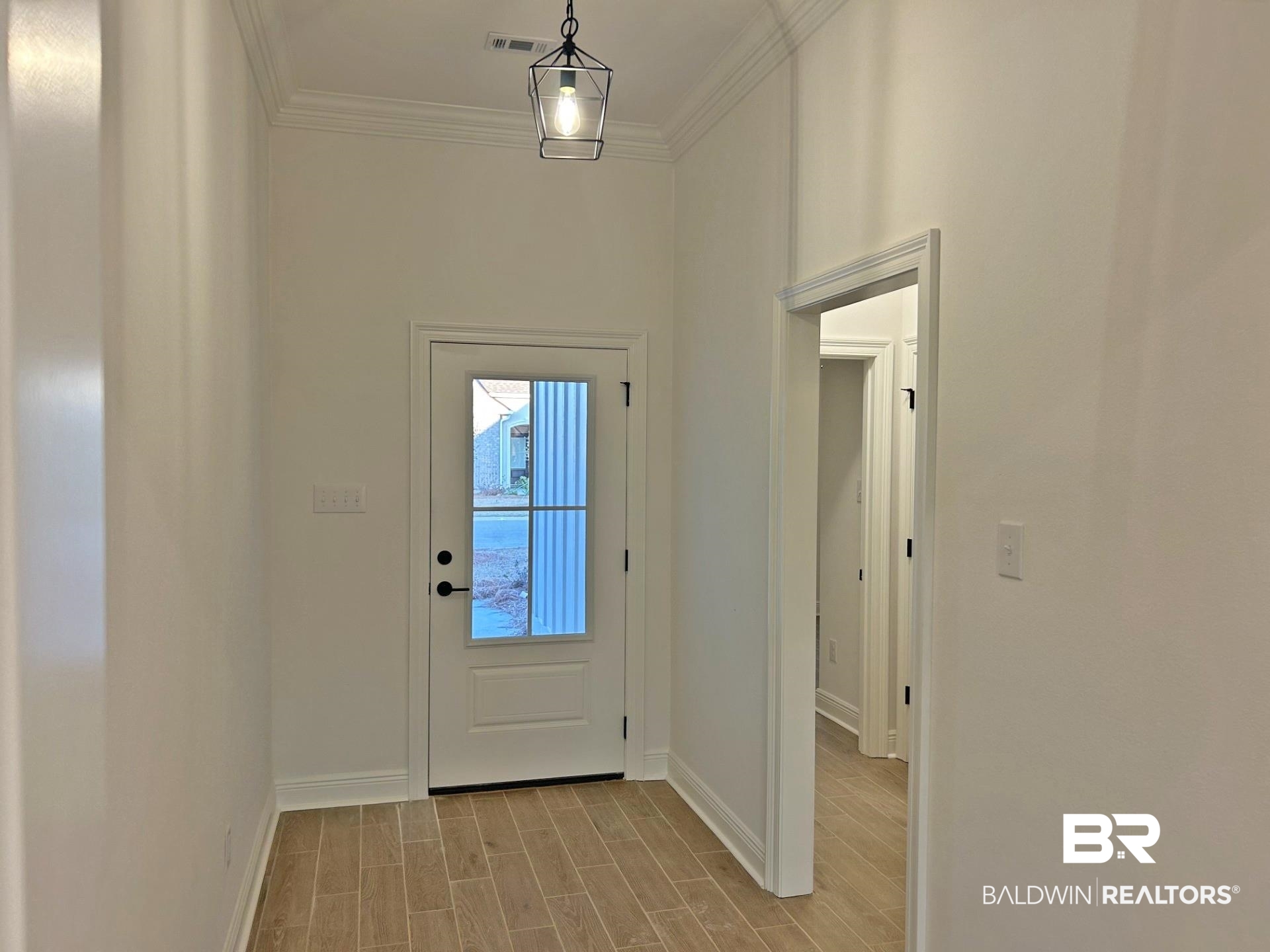 1744 Breckinridge Place Foley, AL 36535 - Photo 3 of 26 Doorway featuring wood tiled floors and crown molding