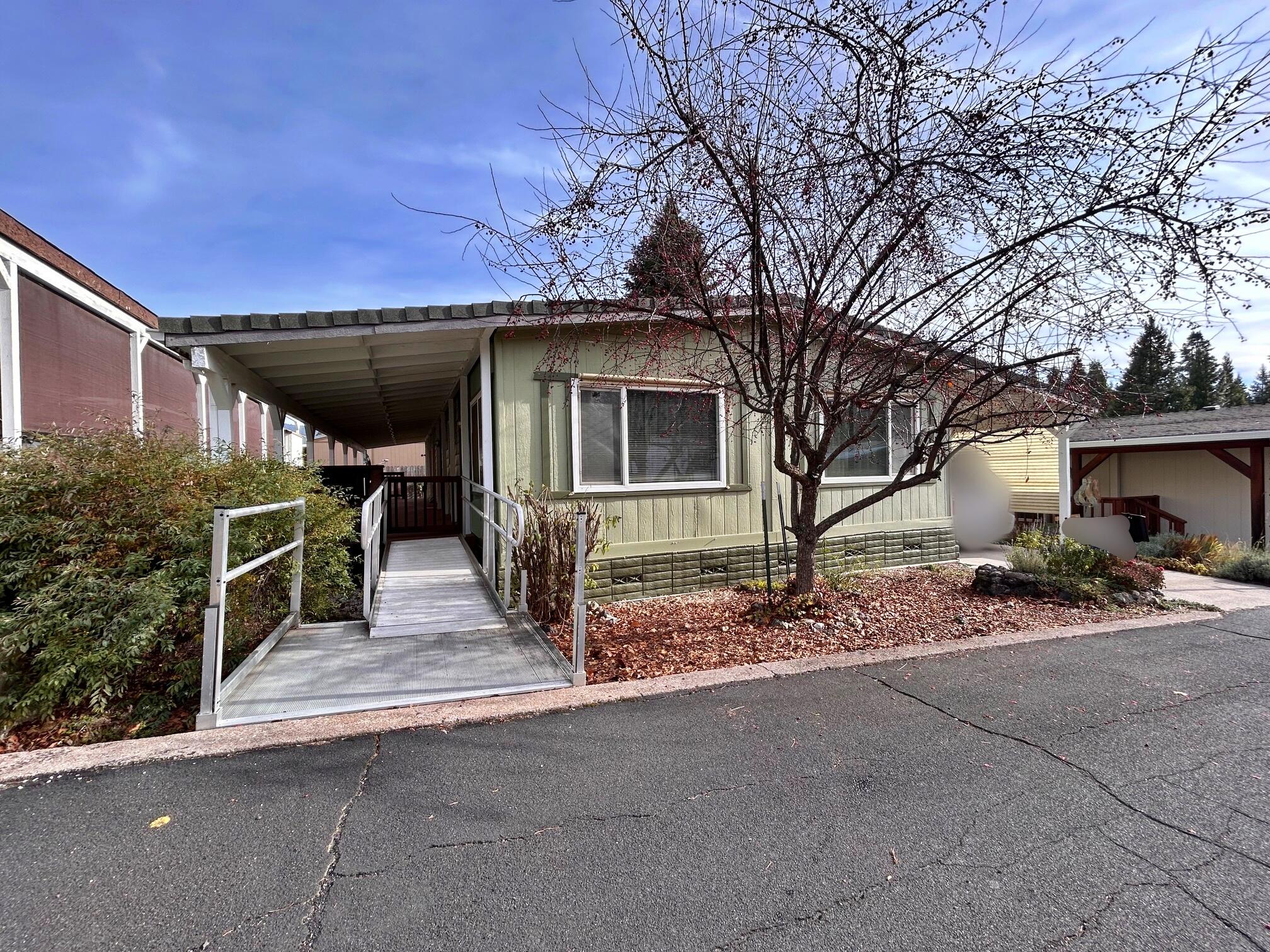 a view of house with yard and garage
