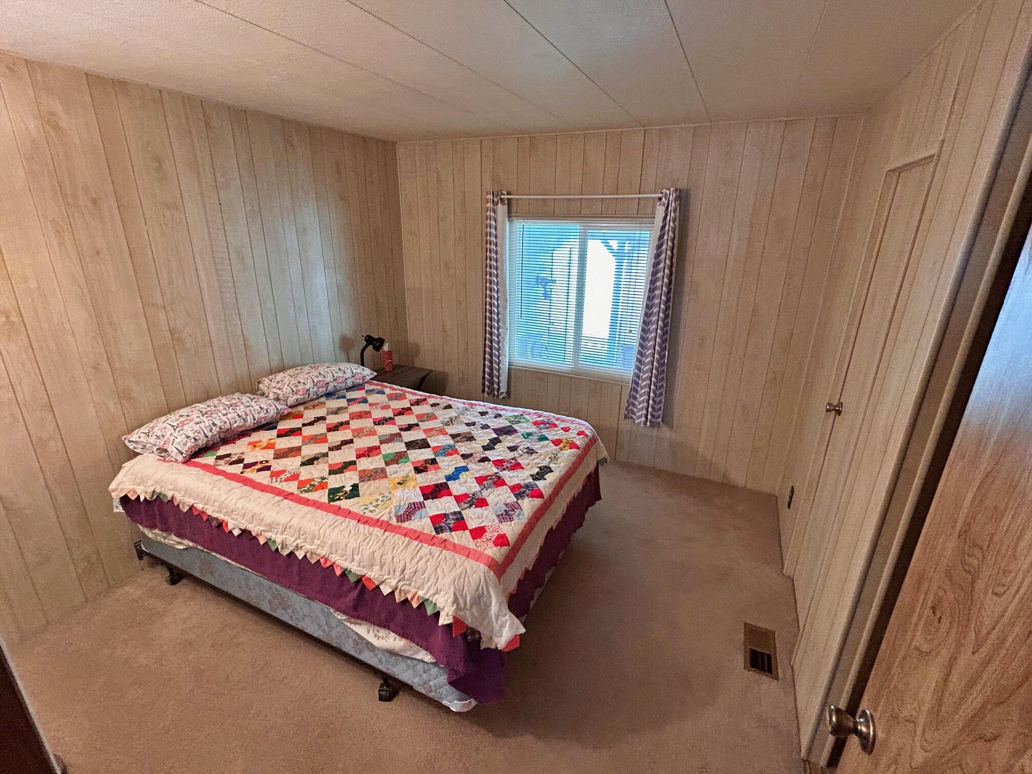 1934 South Old Stage Road, Unit SPC 10 Mount Shasta, CA 96067 - Photo 6 of 12 a bed sitting in a bedroom next to a window