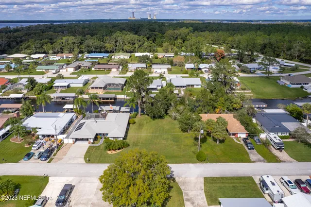 an aerial view of a house with a yard