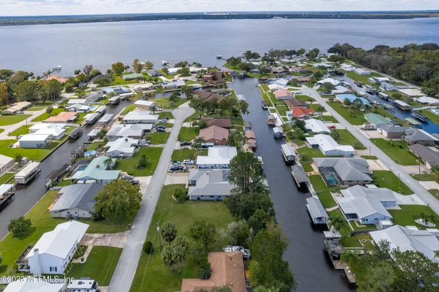 an aerial view of a tennis ground and a cars park