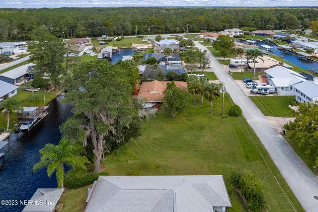 an aerial view of a house with a yard
