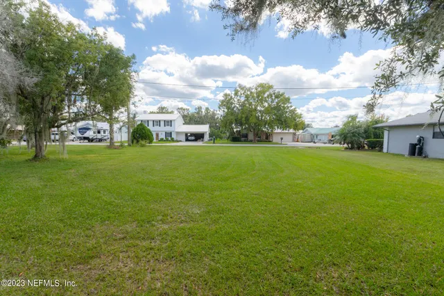 a view of green field with sitting area