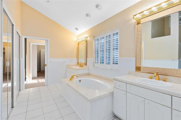 a bathroom with a granite countertop toilet sink and mirror