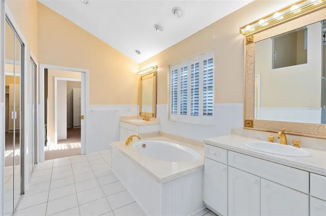 a bathroom with a granite countertop toilet sink and mirror