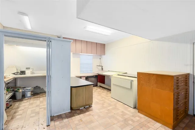 a spacious bedroom with a bed and a dresser