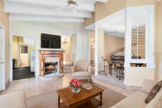 a living room with furniture a fireplace and a flat screen tv