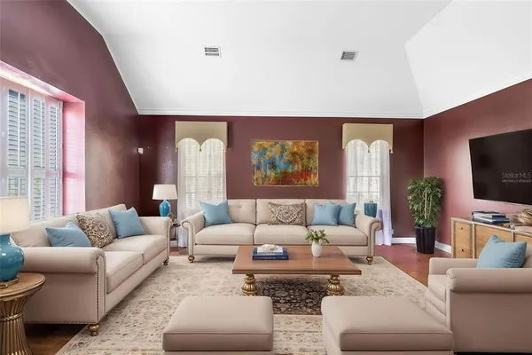 a living room with furniture and a flat screen tv