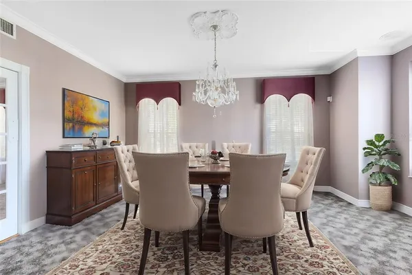 a view of a dining room with furniture and chandelier