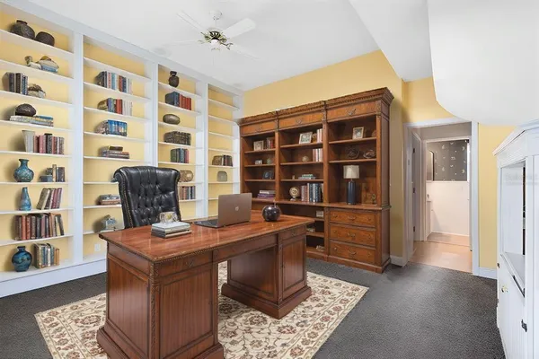 a view of a workspace with furniture and wooden floor