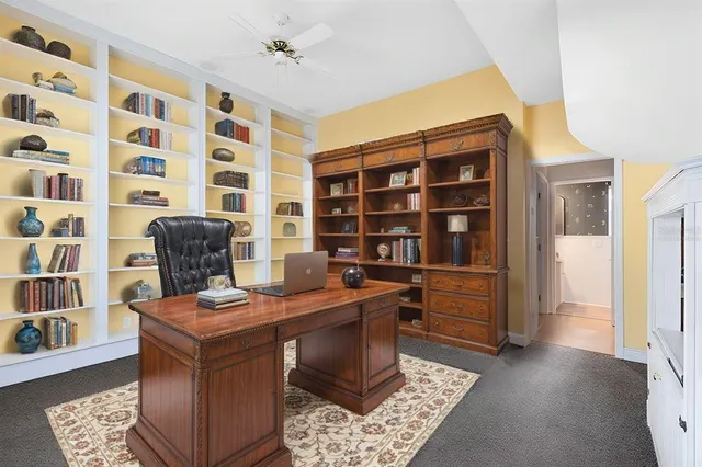 a view of a workspace with furniture and wooden floor