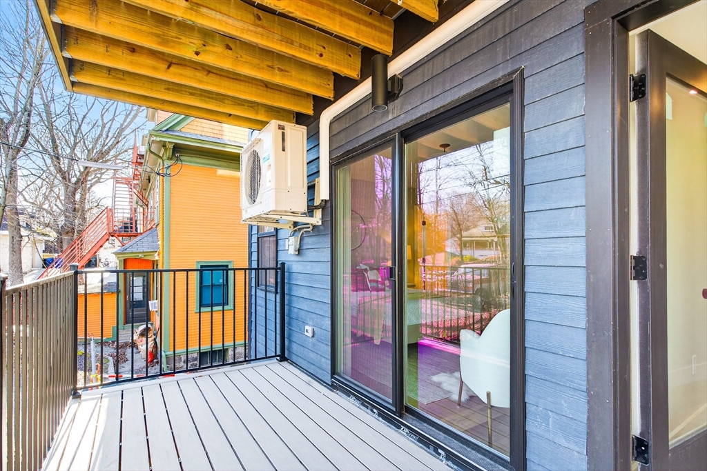 584 Cambridge Street, Unit 1 Boston, MA 02134 - Photo 13 of 17 a view of porch with a door and wooden floor