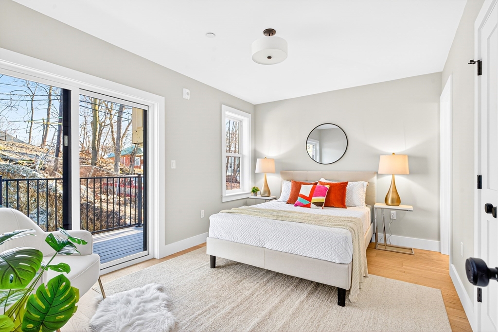 584 Cambridge Street, Unit 1 Boston, MA 02134 - Photo 4 of 17 a bedroom with a bed and a lamp