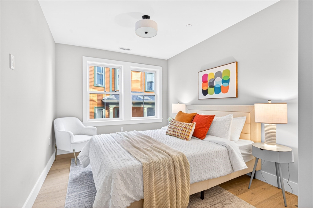 584 Cambridge Street, Unit 1 Boston, MA 02134 - Photo 8 of 17 a bedroom with a bed and a painting on the wall