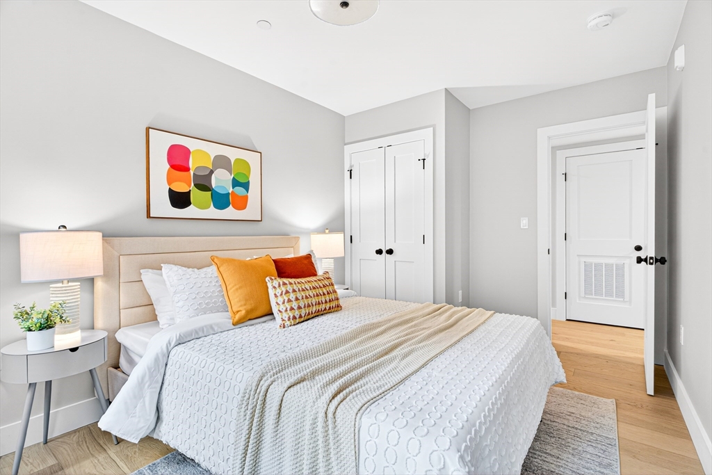 584 Cambridge Street, Unit 1 Boston, MA 02134 - Photo 9 of 17 a bedroom with a bed and painting on the wall