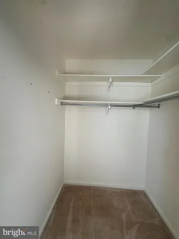 a view of a room with shelf on the wall