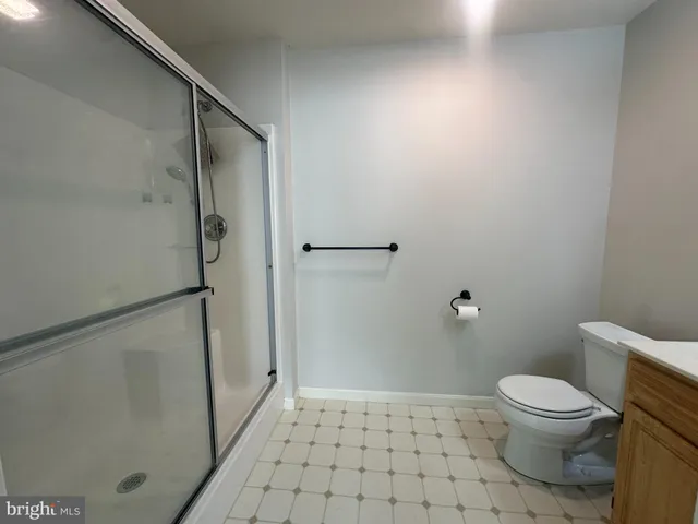 a bathroom with a toilet and a shower