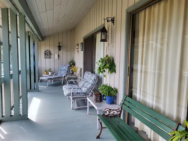 a porch with outdoor seating
