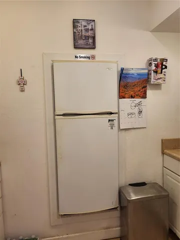a white refrigerator freezer sitting in a kitchen