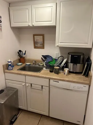 a kitchen with a sink and cabinets